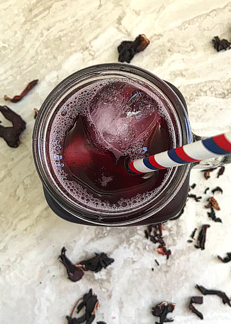 Top view of a mug of sorrel juice. with the petals around