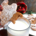 keto gingerbread man being dunked into a cup of milk