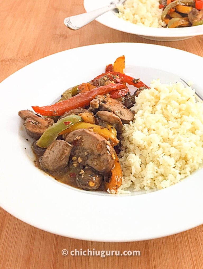 a white plate of cauliflower rice with mushroom stir fry